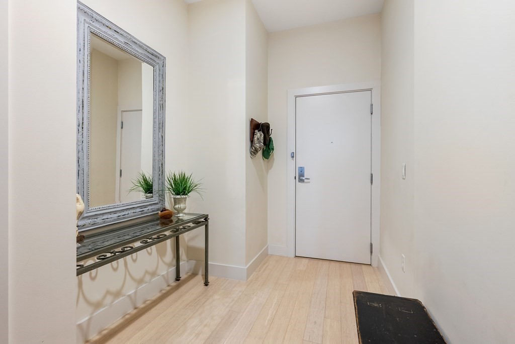 121 Portland Street, Unit 206 Boston, MA 02114 - Photo 25 of 35 a view of empty room with wooden floor and stairs