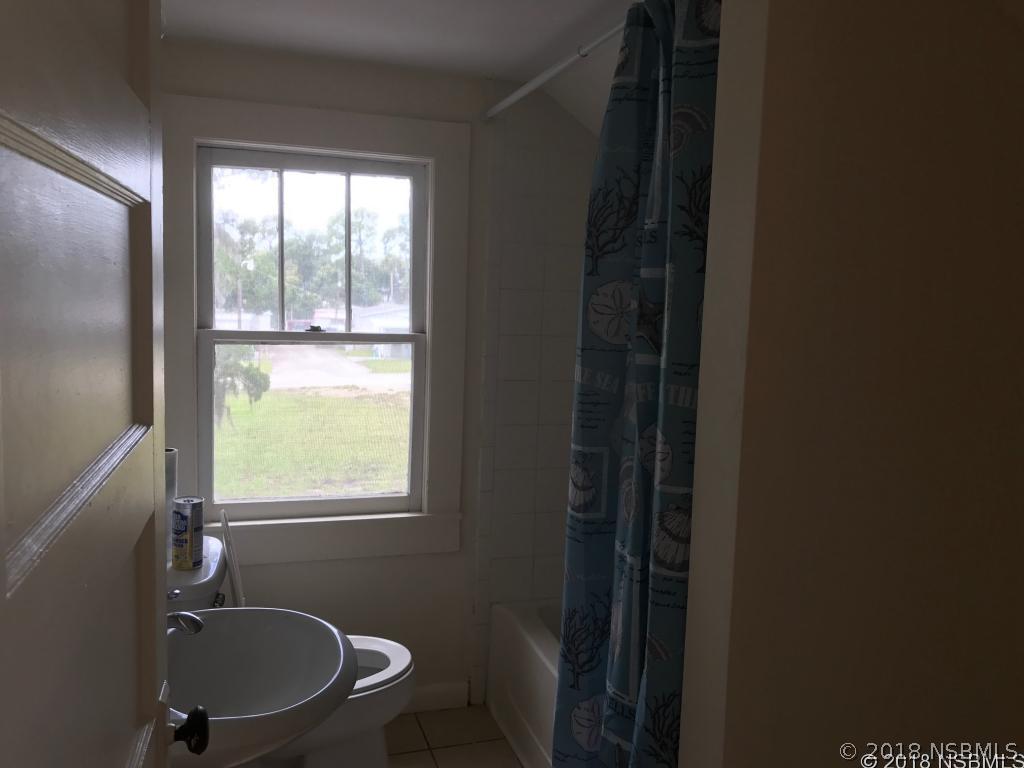 111 Snyder Street Edgewater, FL 32132 - Photo 14 of 16 a bathroom with a sink toilet and shower