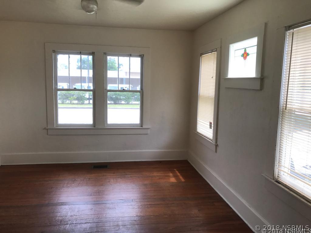 111 Snyder Street Edgewater, FL 32132 - Photo 3 of 16 a view of empty room with wooden floor and fan