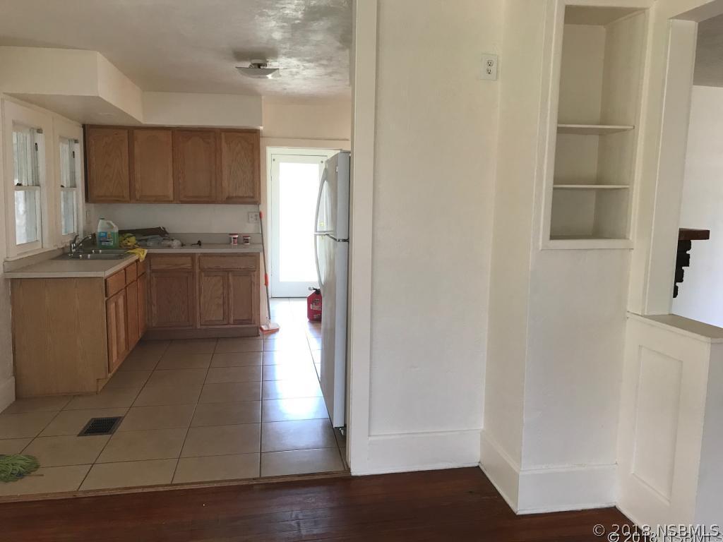 111 Snyder Street Edgewater, FL 32132 - Photo 5 of 16 a kitchen with stainless steel appliances granite countertop a refrigerator and a sink