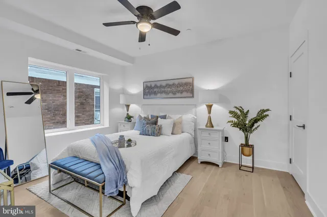 a bedroom with a large bed and a chandelier