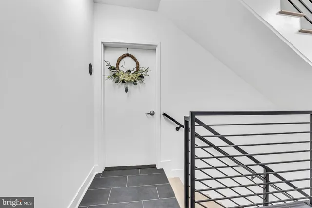 a view of a hallway with wooden floor and a potted plant