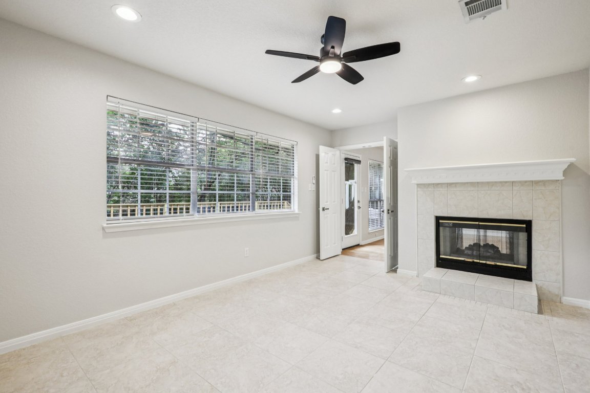 8109 Isaac Pryor Drive Austin, TX 78749 - Photo 12 of 20 a view of an empty room with a fireplace and a window
