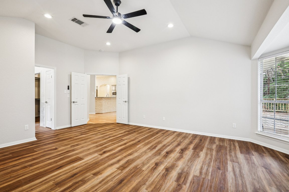 8109 Isaac Pryor Drive Austin, TX 78749 - Photo 14 of 20 a view of empty room with wooden floor and windows