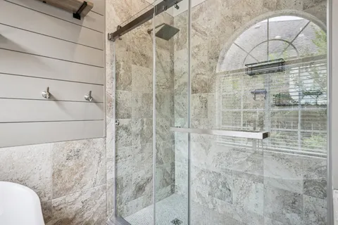 a bathroom with a glass shower door and sink
