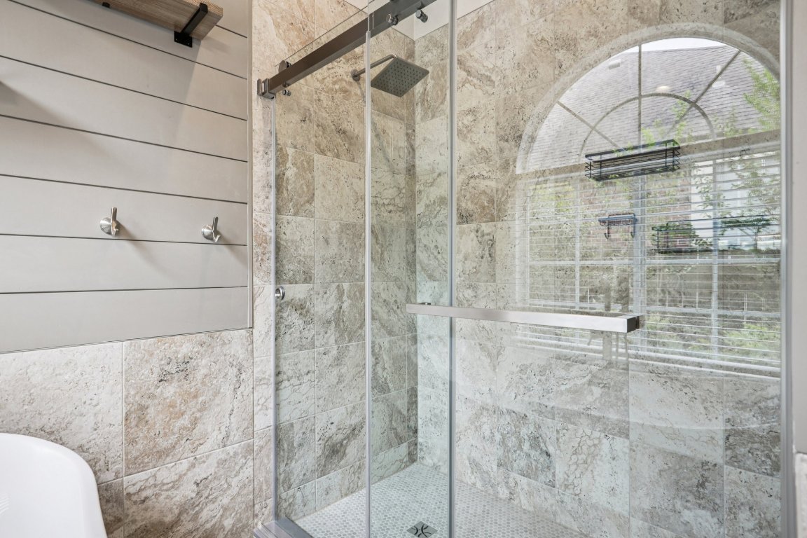 8109 Isaac Pryor Drive Austin, TX 78749 - Photo 17 of 20 a bathroom with a glass shower door and sink