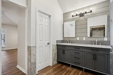 a bathroom with a double vanity sink and mirror