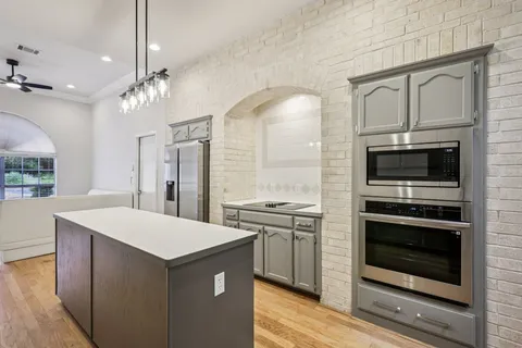 a kitchen with a stove oven and kitchen island