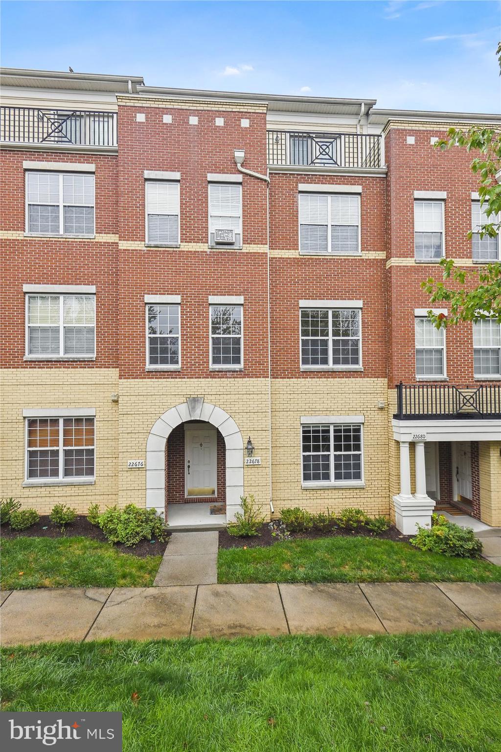 22678 Verde Gate Terrace Brambleton, VA 20148 - Photo 1 of 39 a front view of a house with a yard