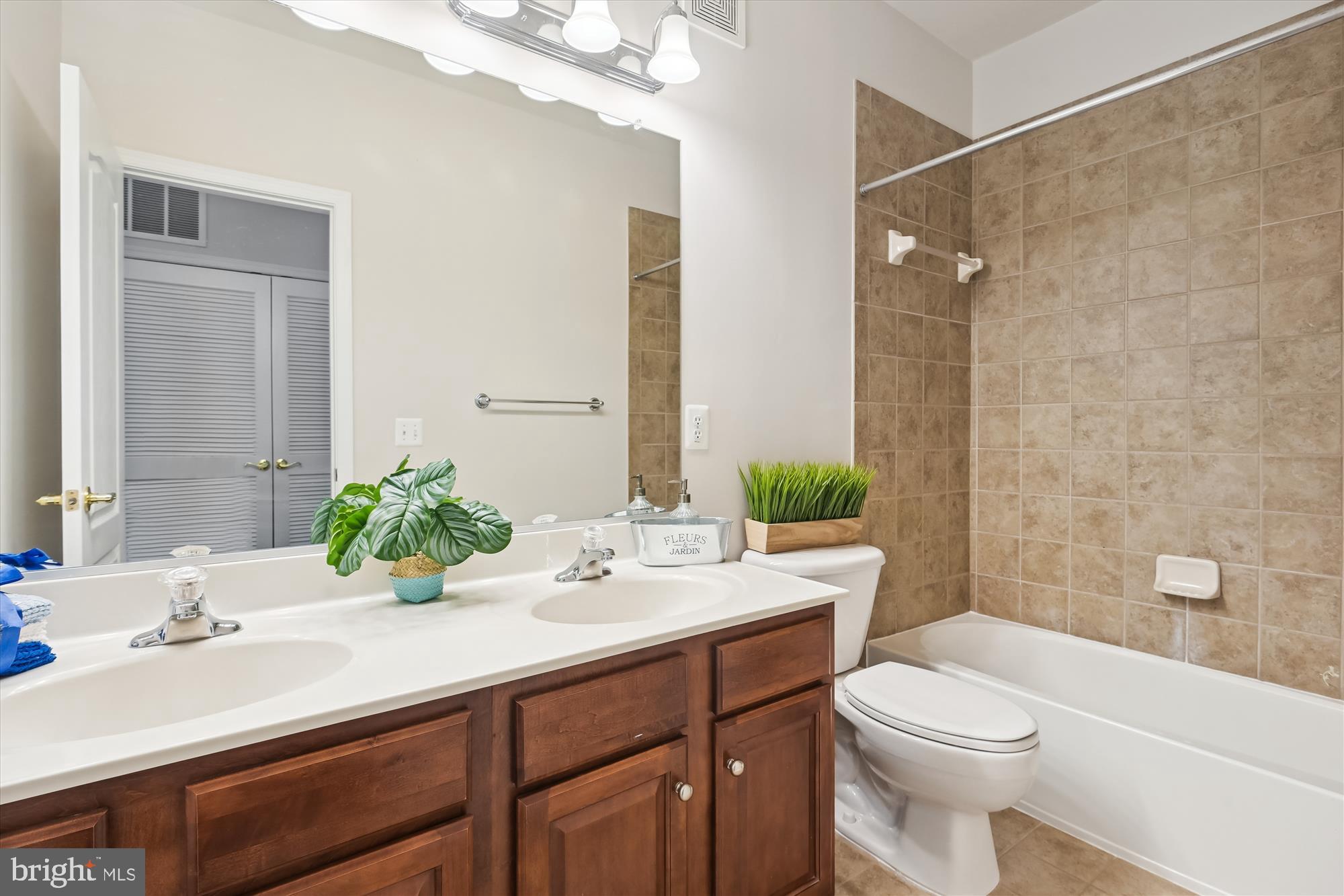 22678 Verde Gate Terrace Brambleton, VA 20148 - Photo 14 of 39 a bathroom with a double vanity sink toilet and shower