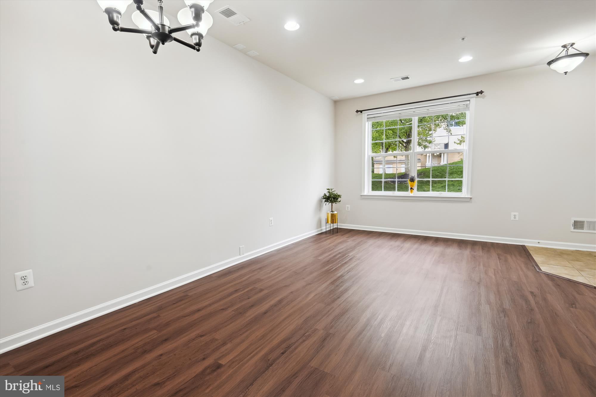 22678 Verde Gate Terrace Brambleton, VA 20148 - Photo 5 of 39 an empty room with wooden floor and windows