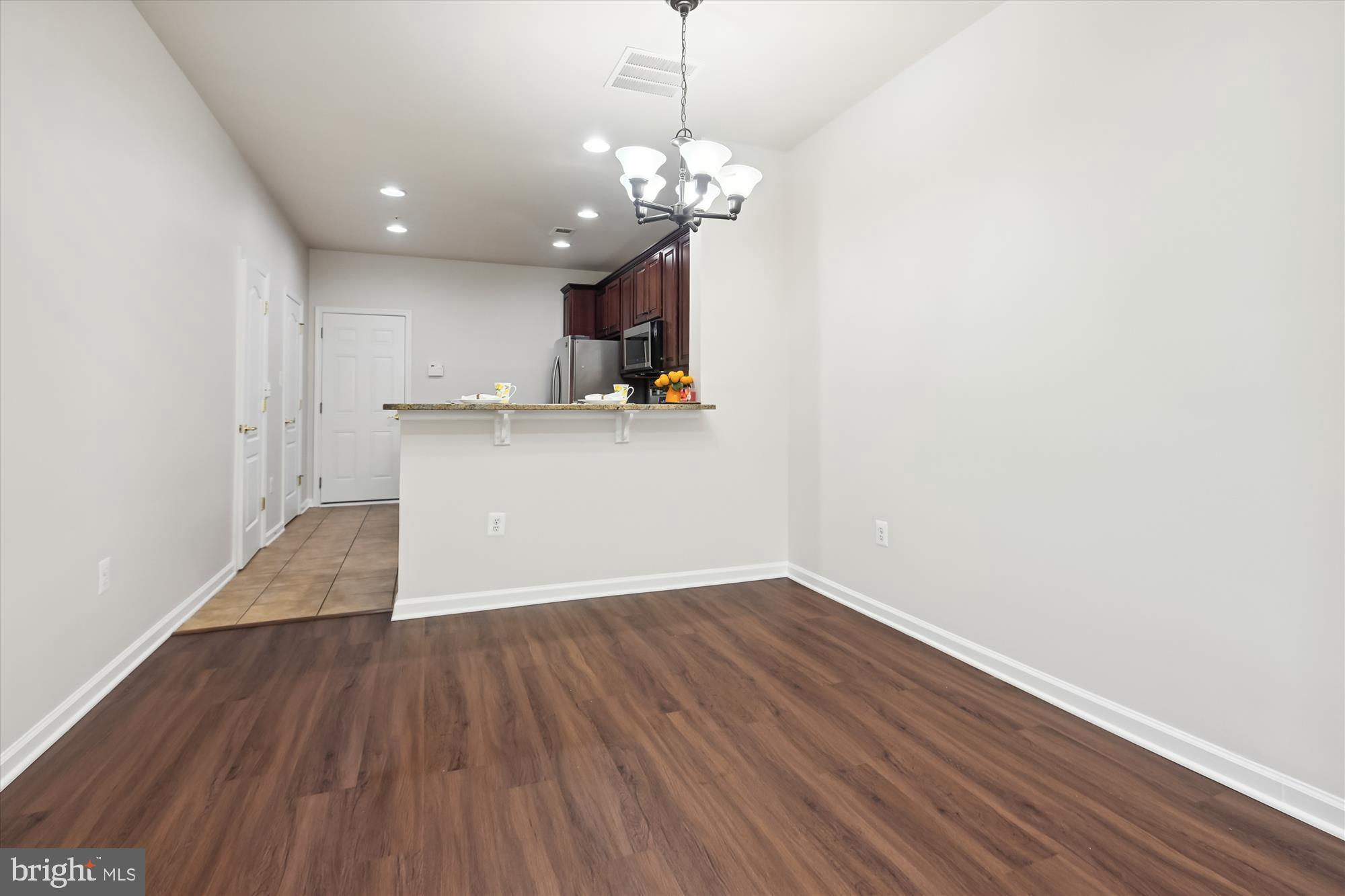 22678 Verde Gate Terrace Brambleton, VA 20148 - Photo 6 of 39 a view of a kitchen with a dishwasher and wooden floor