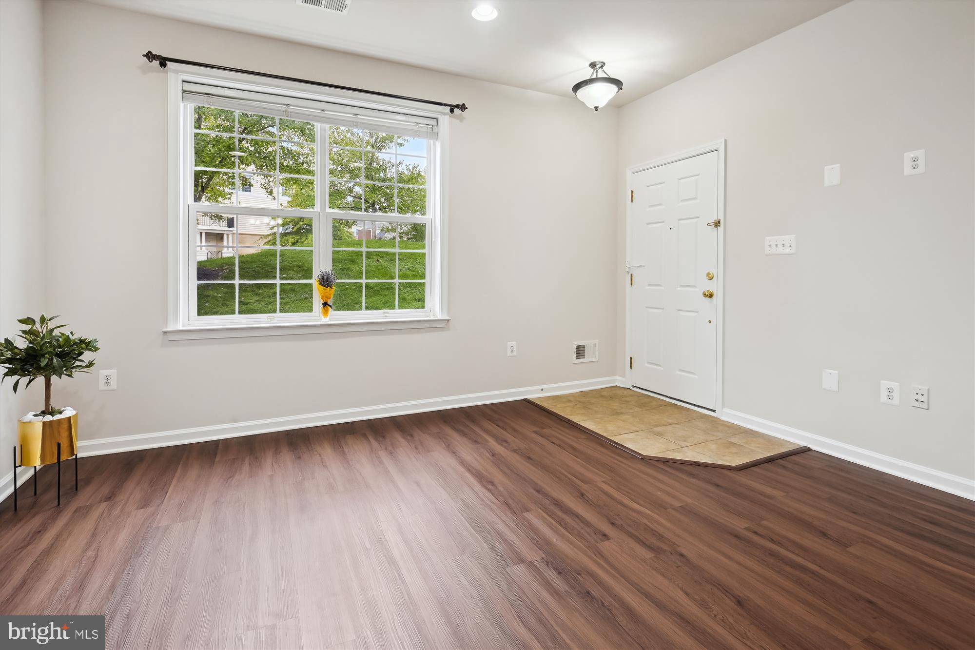 22678 Verde Gate Terrace Brambleton, VA 20148 - Photo 10 of 39 an empty room with wooden floor and windows