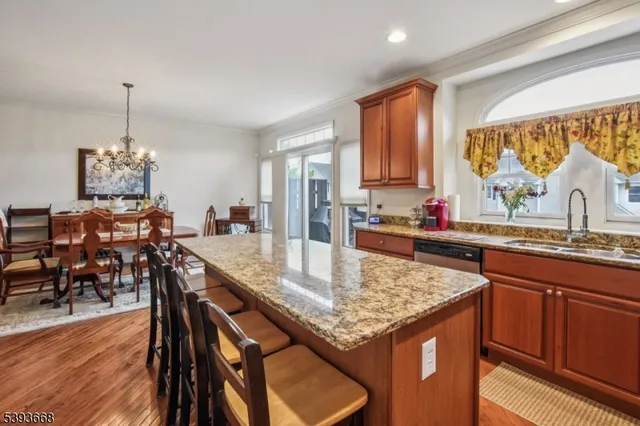a kitchen with granite countertop kitchen island a table and chairs in it