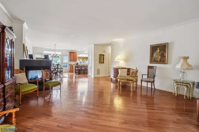 a living room with fireplace furniture and a wooden floor
