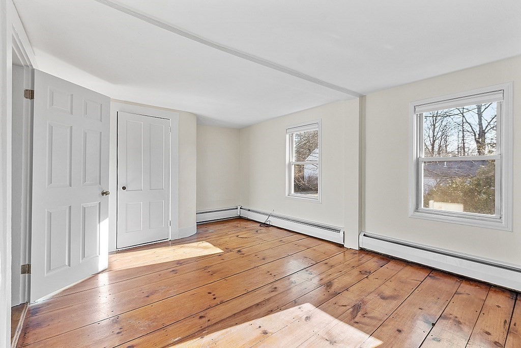 8 Main Street, Unit 2R Pepperell, MA 01463 - Photo 11 of 13 a view of an empty room with wooden floor and a window