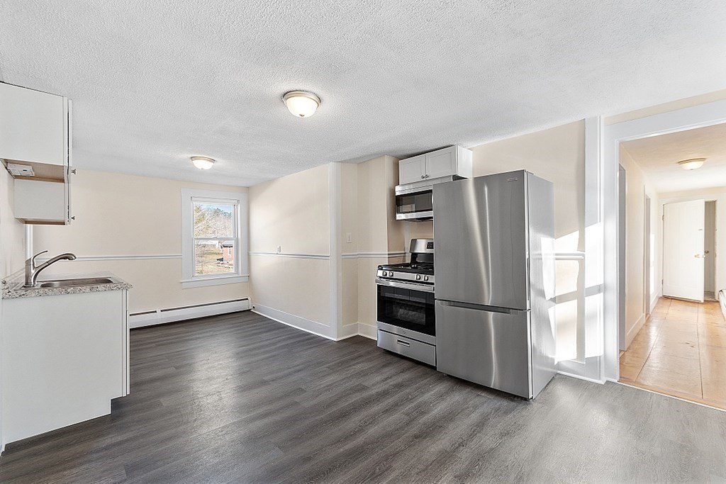 8 Main Street, Unit 2R Pepperell, MA 01463 - Photo 4 of 13 a kitchen with a refrigerator and a stove top oven