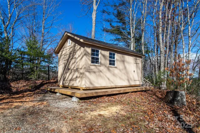 a view of backyard with small cabin