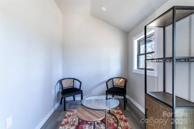 a view of a room with a table and chairs