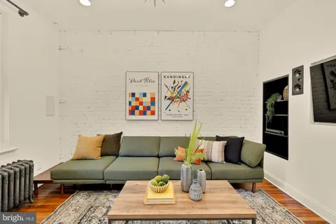 a living room with furniture and painting on the wall