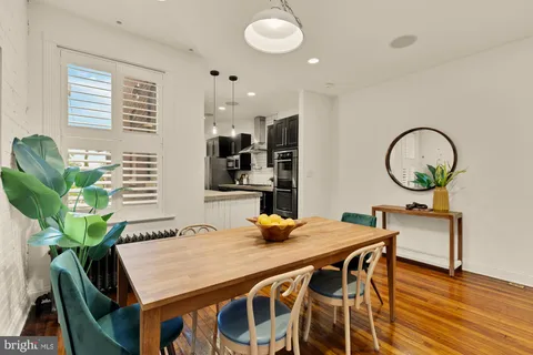 a view of a dining room with furniture and a window