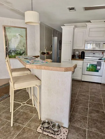 a kitchen with stainless steel appliances granite countertop a sink and a stove