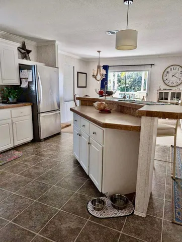 a kitchen with a sink and refrigerator