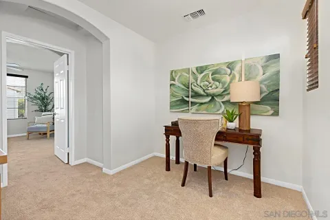 a view of workspace room with window and furniture