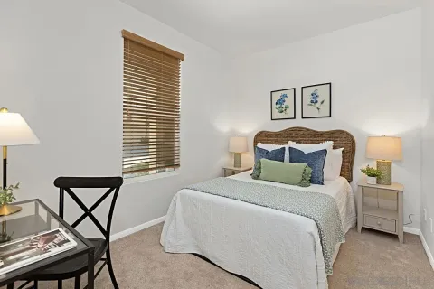 a bedroom with a bed and a lamp on table