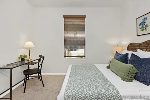 a bedroom with a bed a lamp and a window