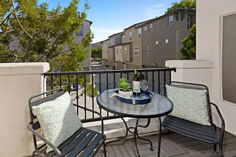 a balcony with table and chairs
