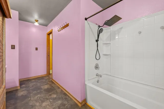 a bathroom with a bathtub shower and a shower