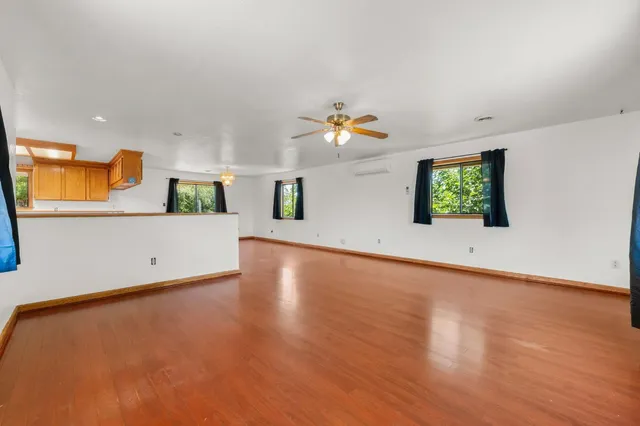 a view of a kitchen with wooden floor and electronic appliances