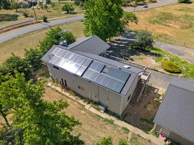 an aerial view of a house with a yard