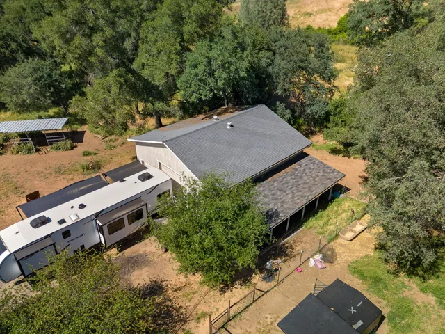 an aerial view of a house with swimming pool and ocean view