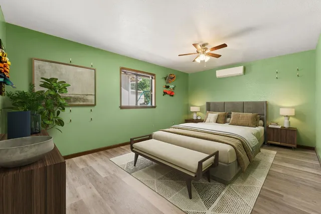 a bedroom with a bed and a potted plant