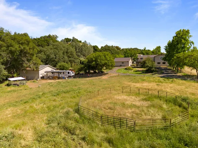 an aerial view of a house with a yard basket ball court and outdoor seating