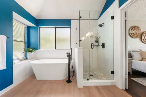 a bathroom with a tub and shower