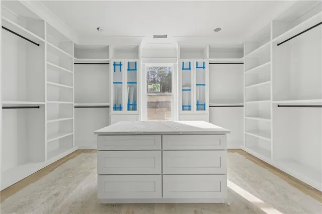 a kitchen with a refrigerator and white cabinets