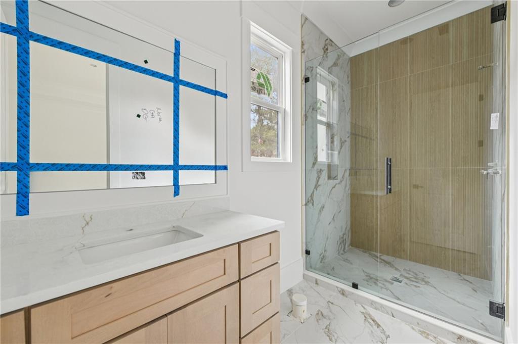 3207 Thompson Mill Road Buford, GA 30519 - Photo 22 of 35 a bathroom with a shower and a sink