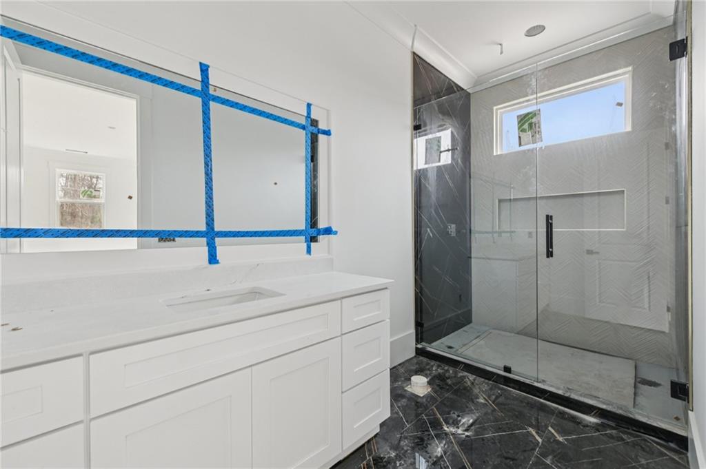 3207 Thompson Mill Road Buford, GA 30519 - Photo 24 of 35 a bathroom with a sink and a mirror