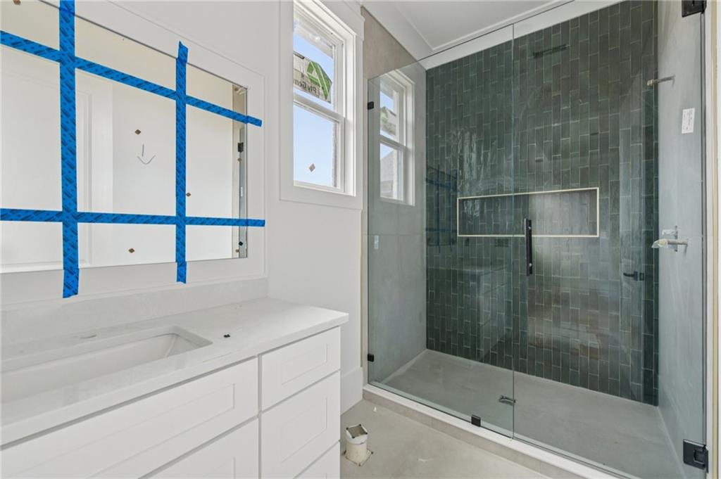 3207 Thompson Mill Road Buford, GA 30519 - Photo 28 of 35 a bathroom with a shower and a bathtub