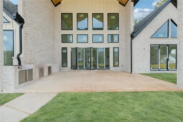a view of a house with a yard balcony and a slide