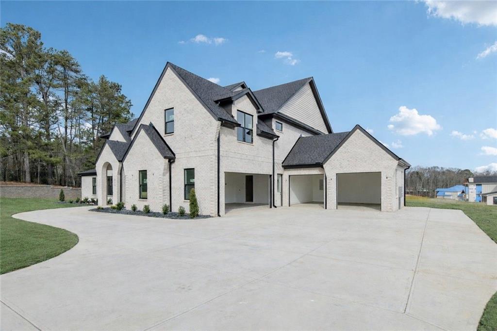 3207 Thompson Mill Road Buford, GA 30519 - Photo 32 of 35 a view of a house with a yard and large trees