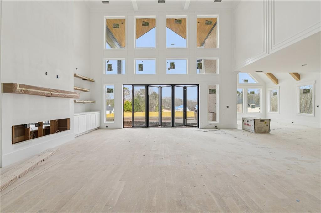 3207 Thompson Mill Road Buford, GA 30519 - Photo 6 of 35 a view of an empty room with a fireplace and a window