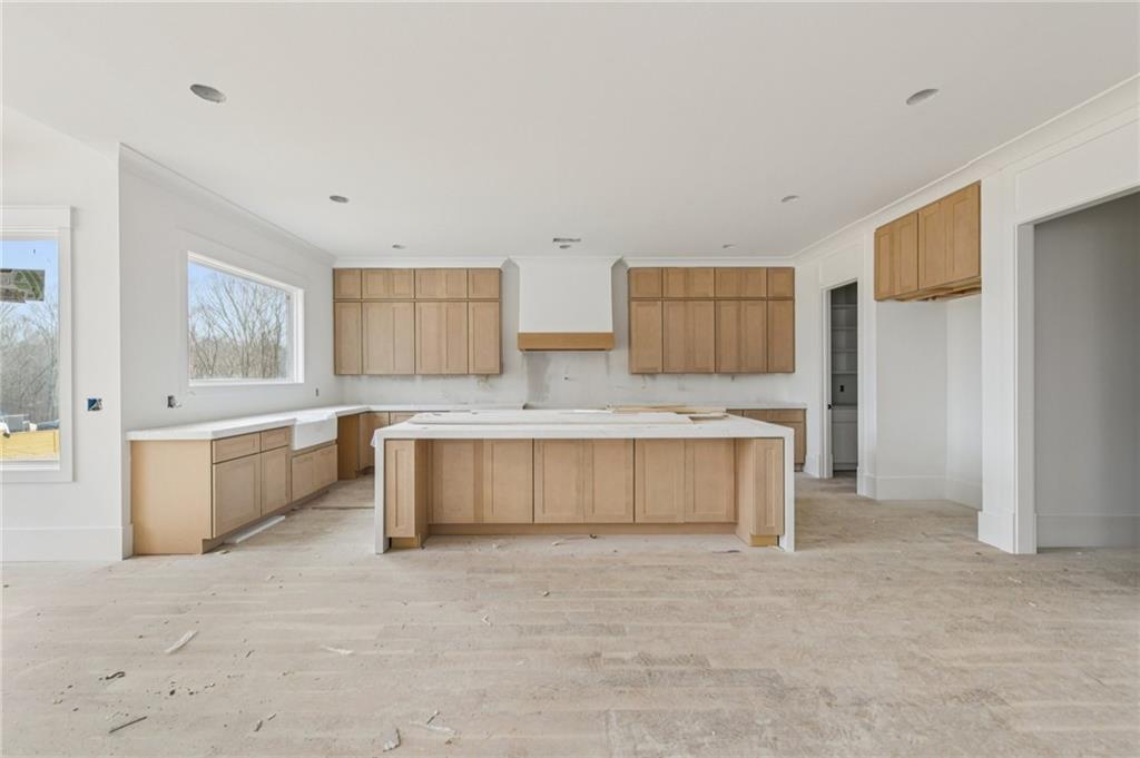 3207 Thompson Mill Road Buford, GA 30519 - Photo 8 of 35 a large white kitchen with a sink and a refrigerator