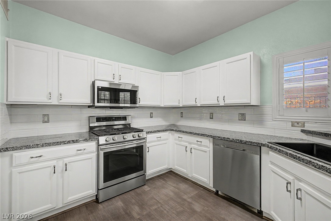2153 Quarry Ridge Street, Unit 103 Las Vegas, NV 89117 - Photo 18 of 42 Culinary delights await in this modern kitchen with granite counters and white shaker cabinetry.