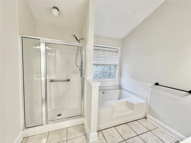 a bathroom with a bathtub and shower