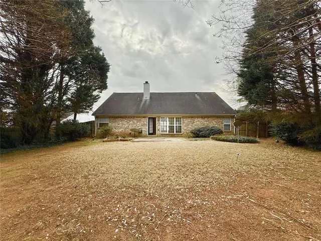 a front view of house with yard and trees