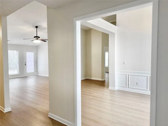 a view of a hallway with wooden floor